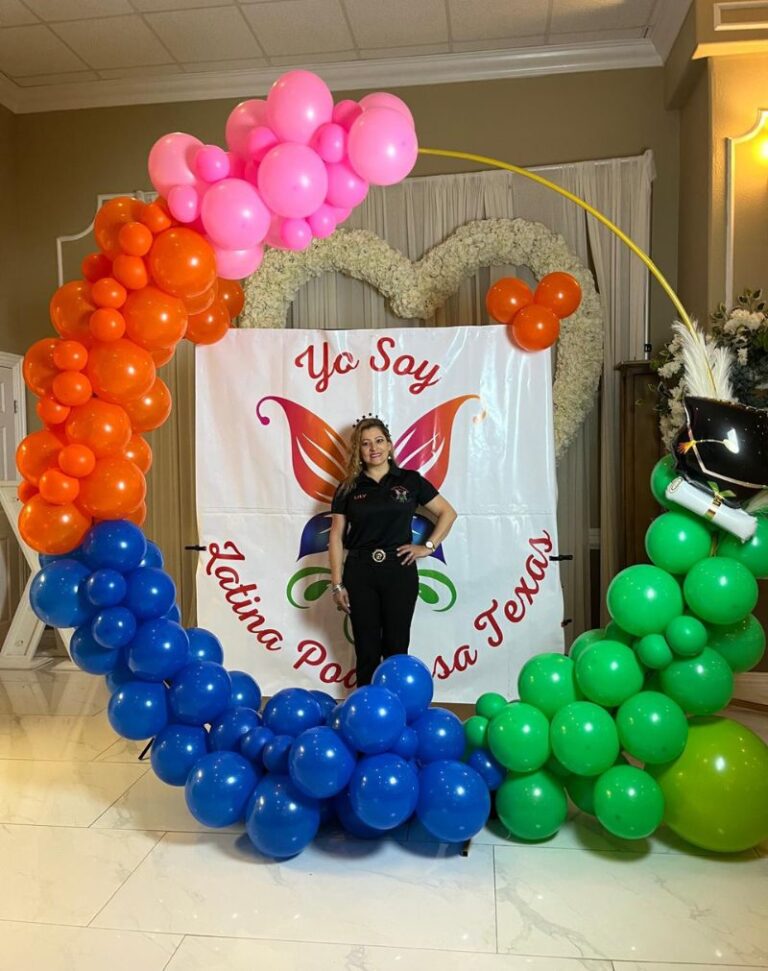 Happy client testimonial at a special event featuring a vibrant balloon decoration with blue, green, orange, and pink tones. Designed by Click Events Houston.